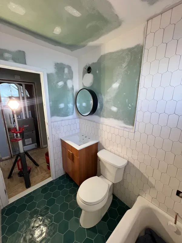A bathroom with a toilet , sink , and bathtub.