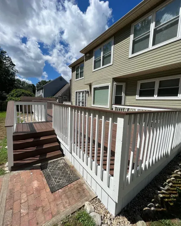 A house with a deck and stairs leading up to it