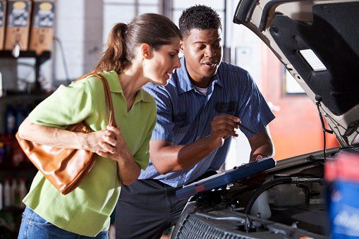 Women Checking Car Engine — Arlington, TX — High Tech Transmission Specialists Women Checking Car Engine — Arlington, TX — High Tech Transmission Specialists
