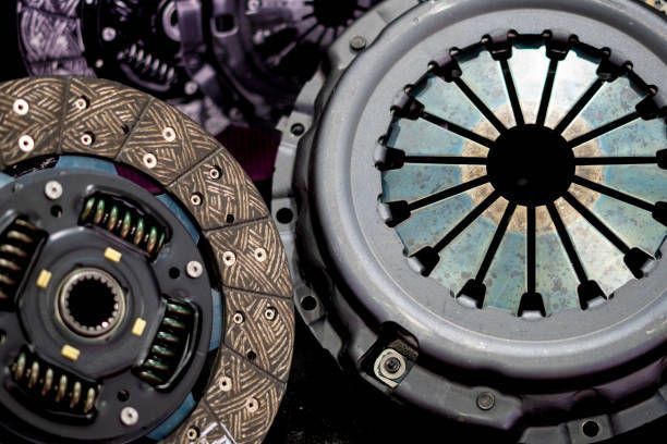 Spare car parts showcasing clutch replacement, with the clutch disc in sharp focus on display.