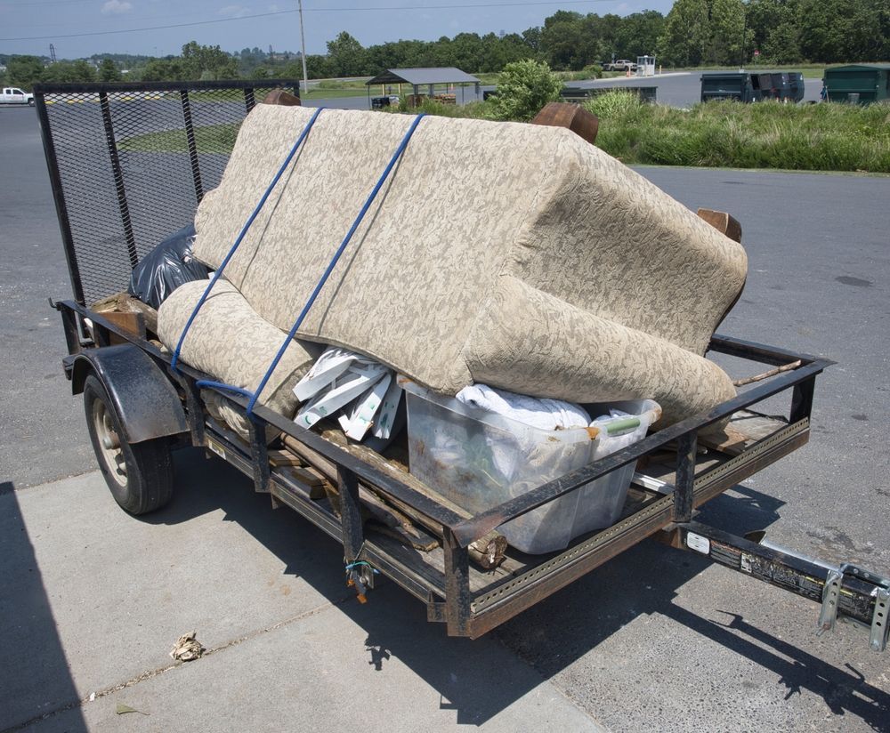 A trailer with a couch and a rug on it