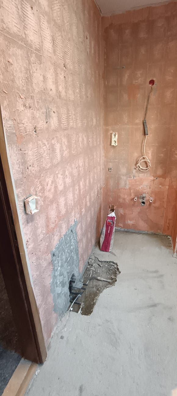A bathroom under construction with a hole in the floor.