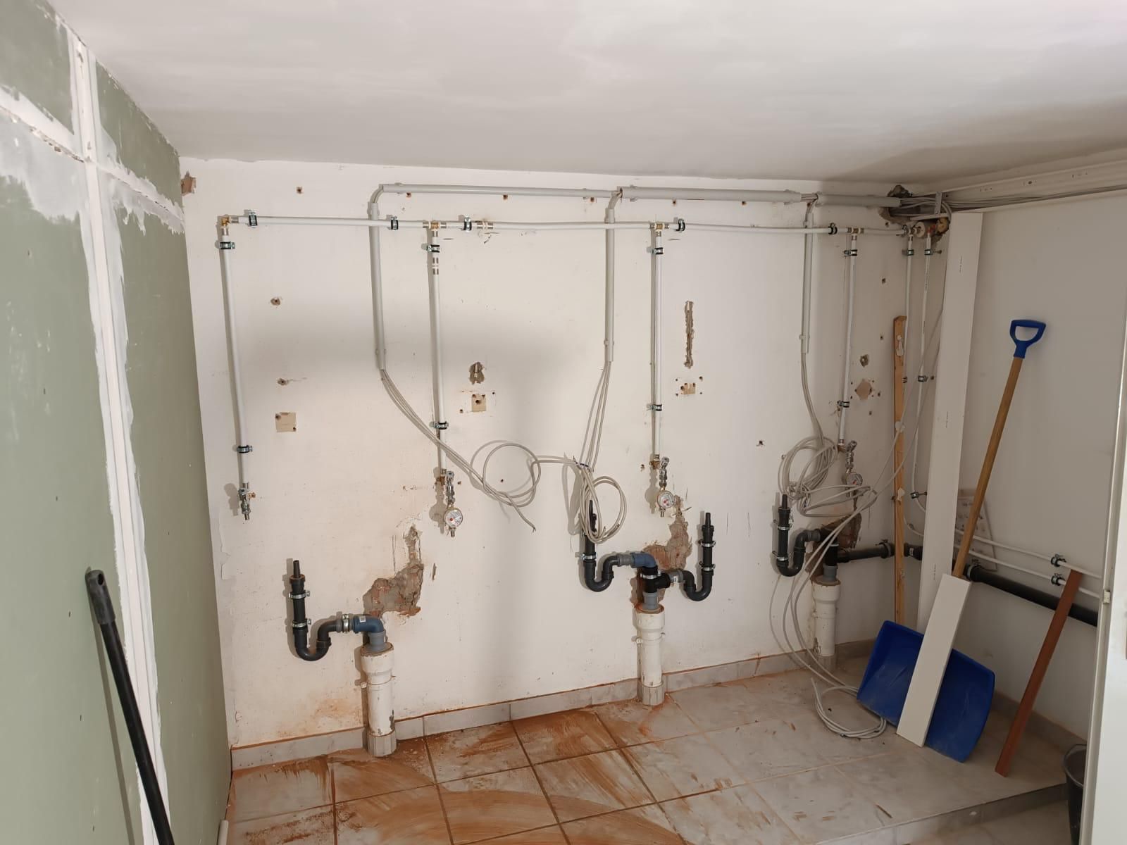 A room with a lot of pipes hanging from the ceiling.