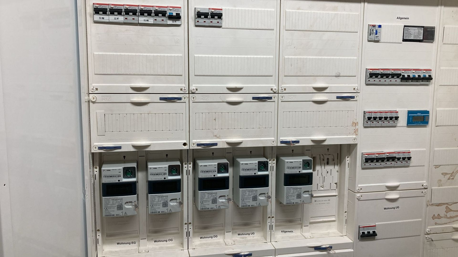 A wall with a lot of electrical equipment on it.