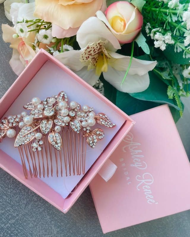 A pink box with a hair comb inside of it