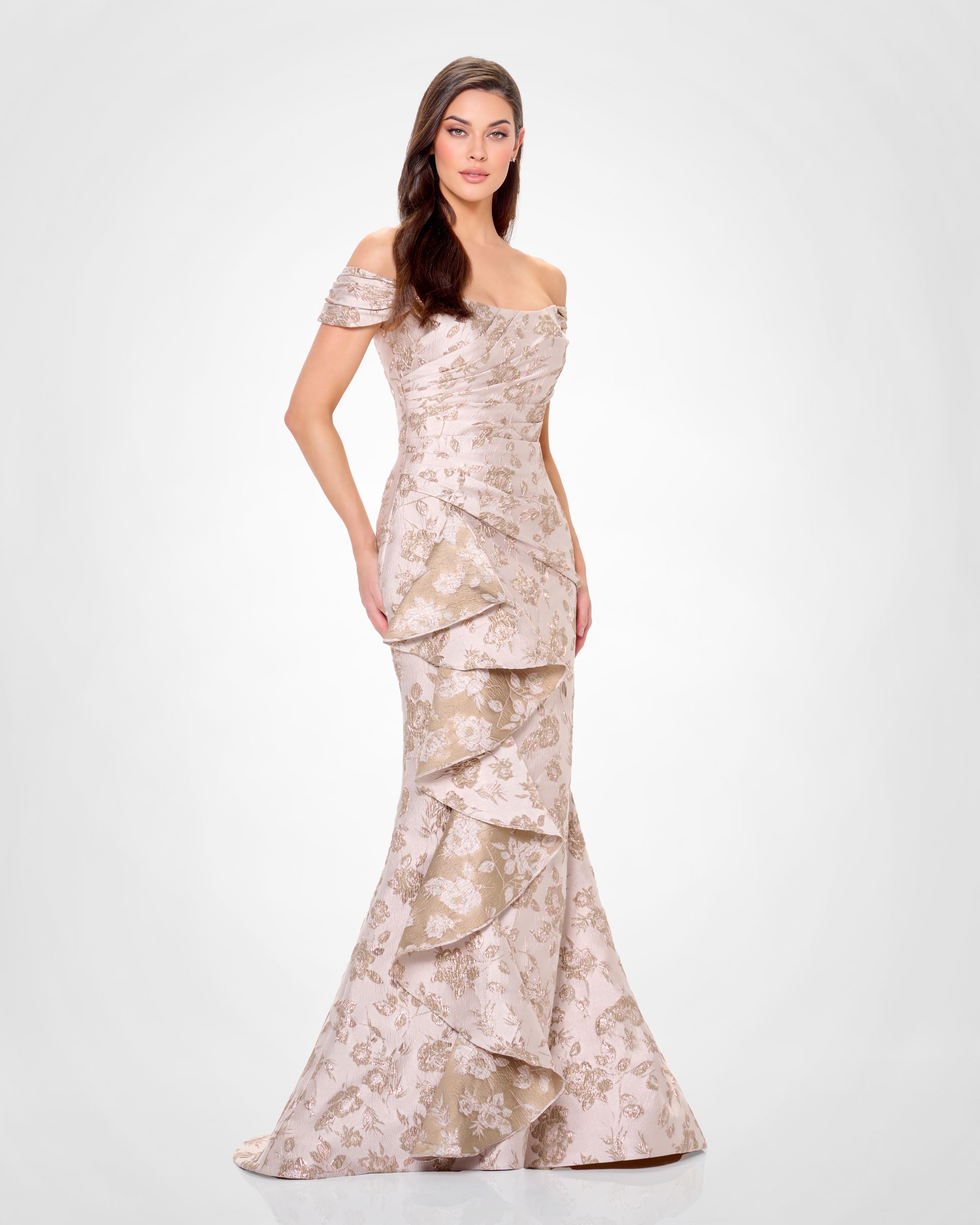 A woman in a long dress is standing on a white background.
