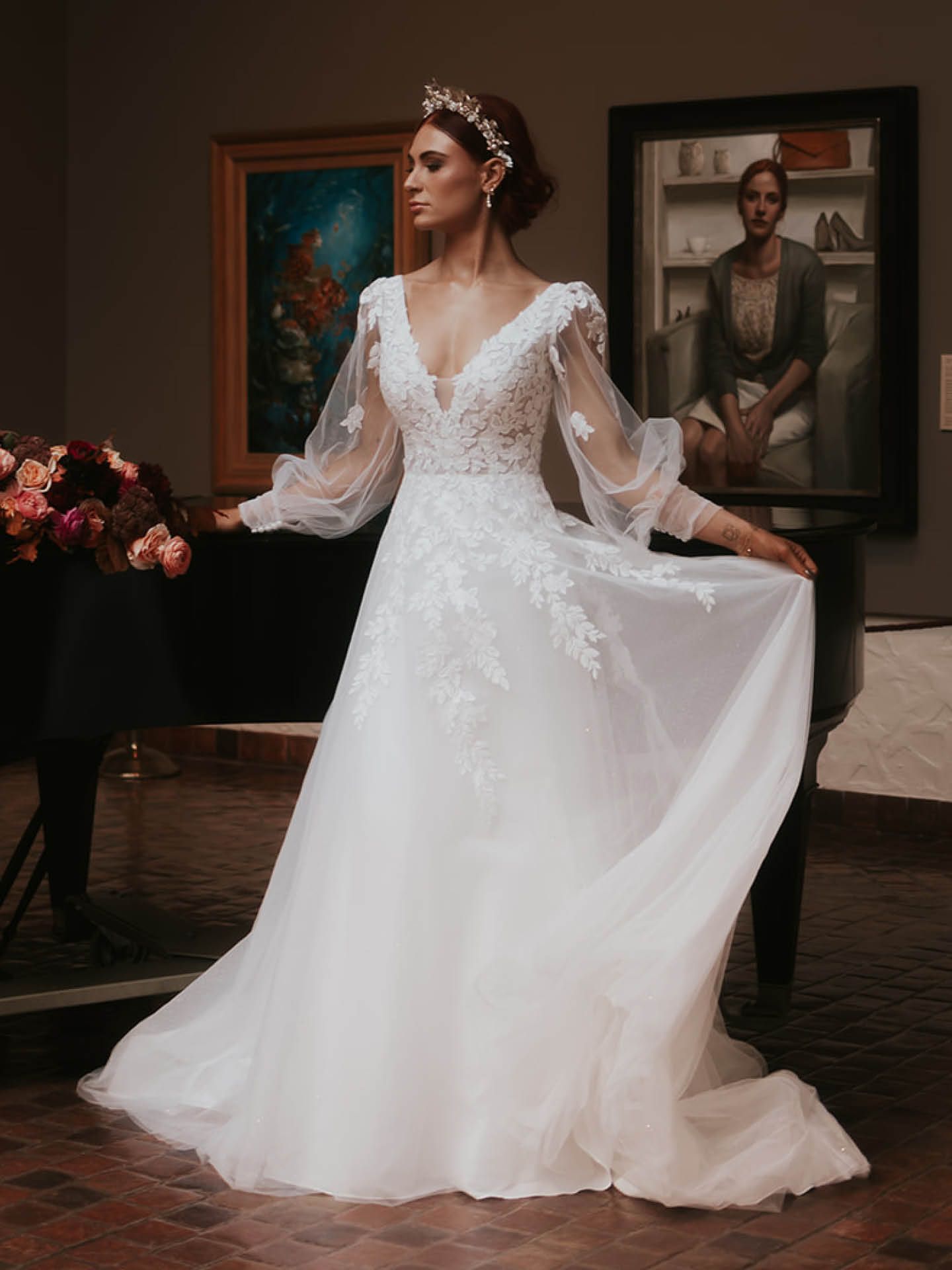 A woman in a wedding dress is standing in front of a piano.