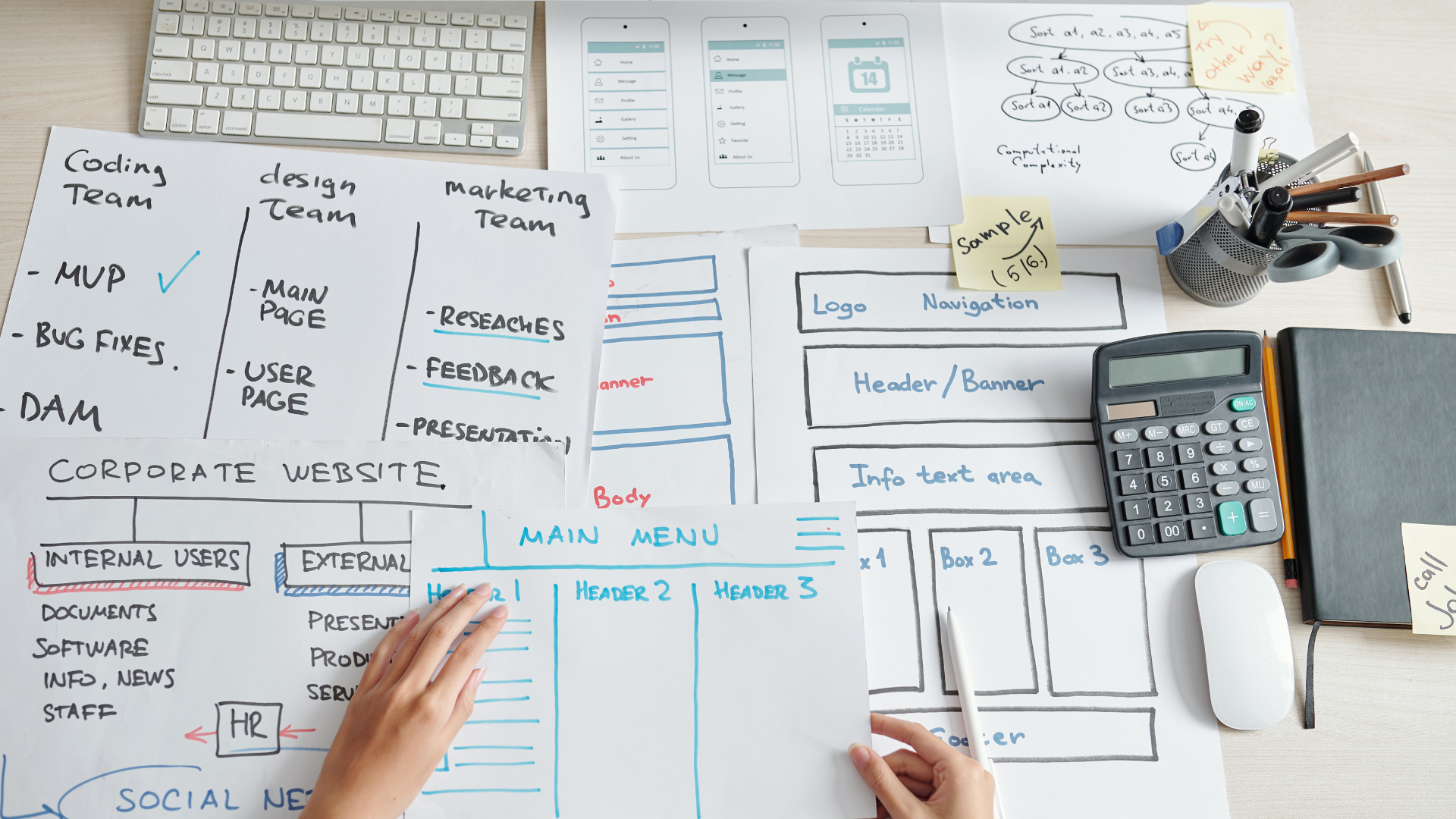 A person is sitting at a desk with a calculator and a keyboard.