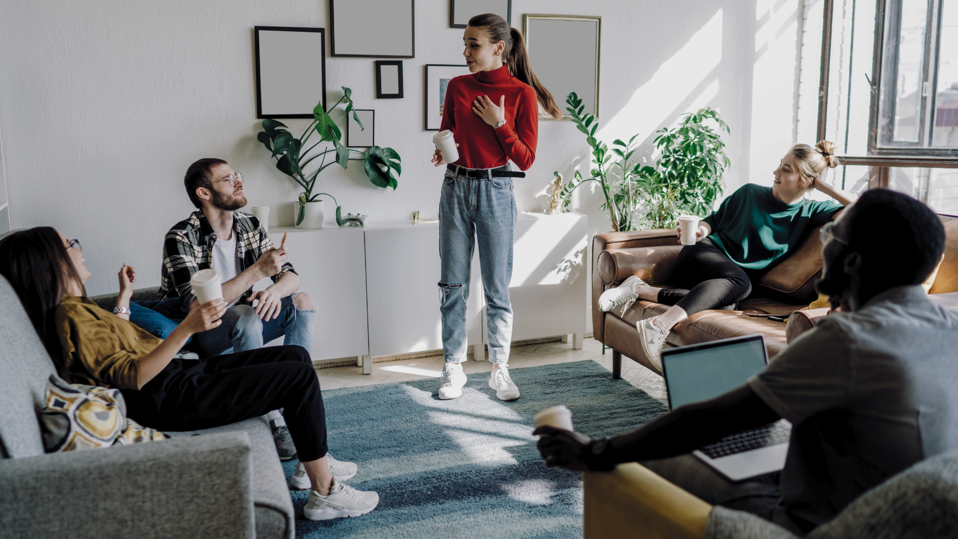 A group of people are sitting on couches in a living room.