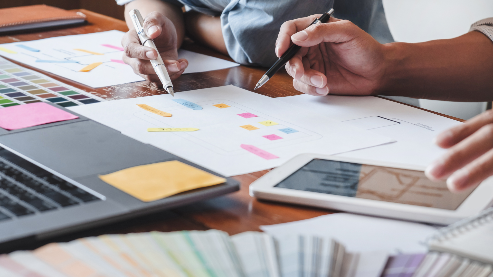 A group of people are sitting at a table working on a project.