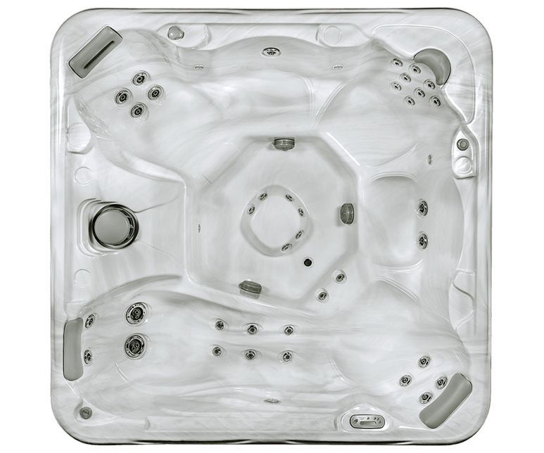 Overhead view of a light-colored hot tub with multiple seating areas and jets.