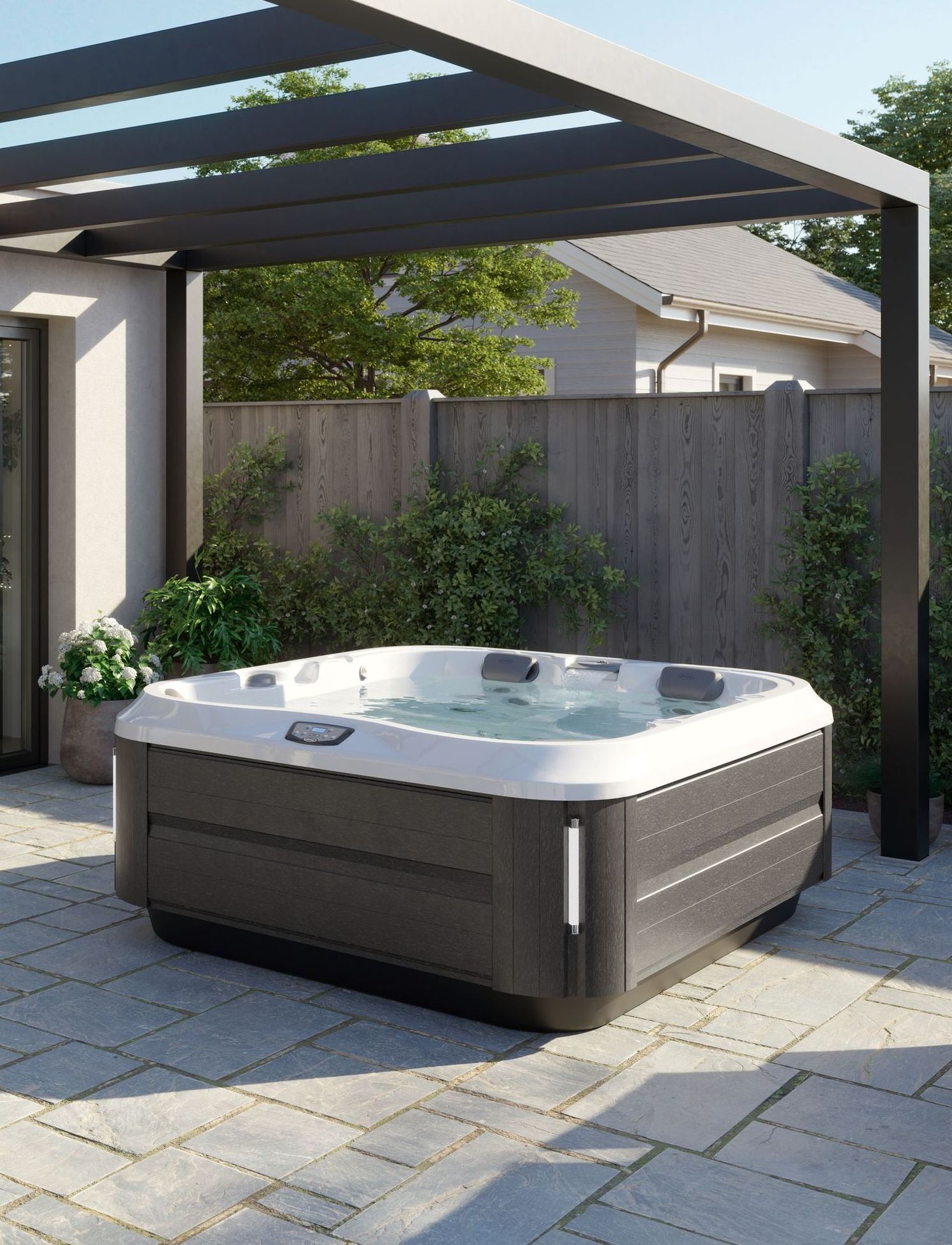 Hot tub in a backyard setting, with dark gray frame and light gray interior, under a dark pergola.
