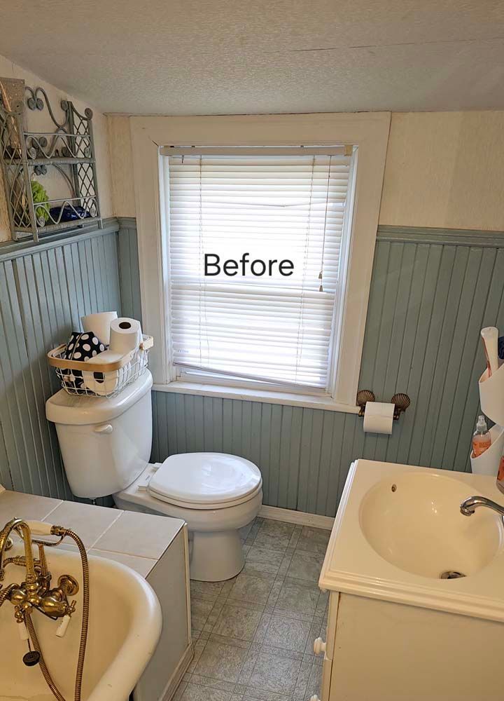 Small bathroom with blue wainscoting, toilet, sink, and window with blinds labeled 