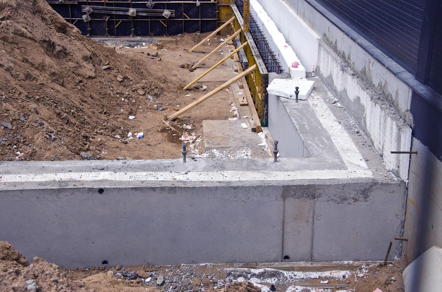 a building under construction with a concrete slab in the foreground