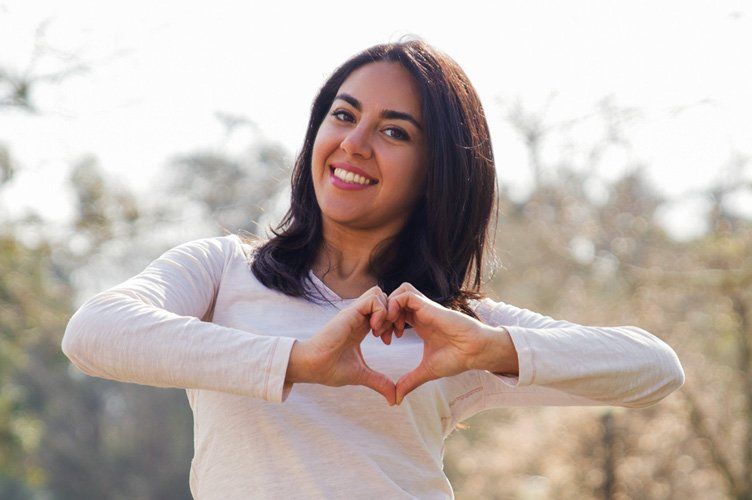 Woman in Round Rock TX  making heart sign with hands