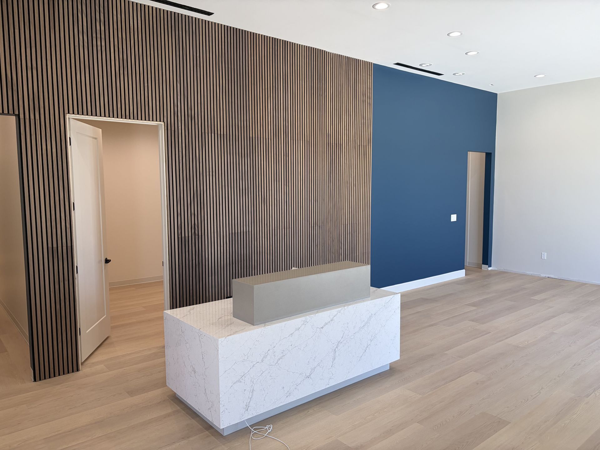 A dental office with a waiting room and a reception desk.