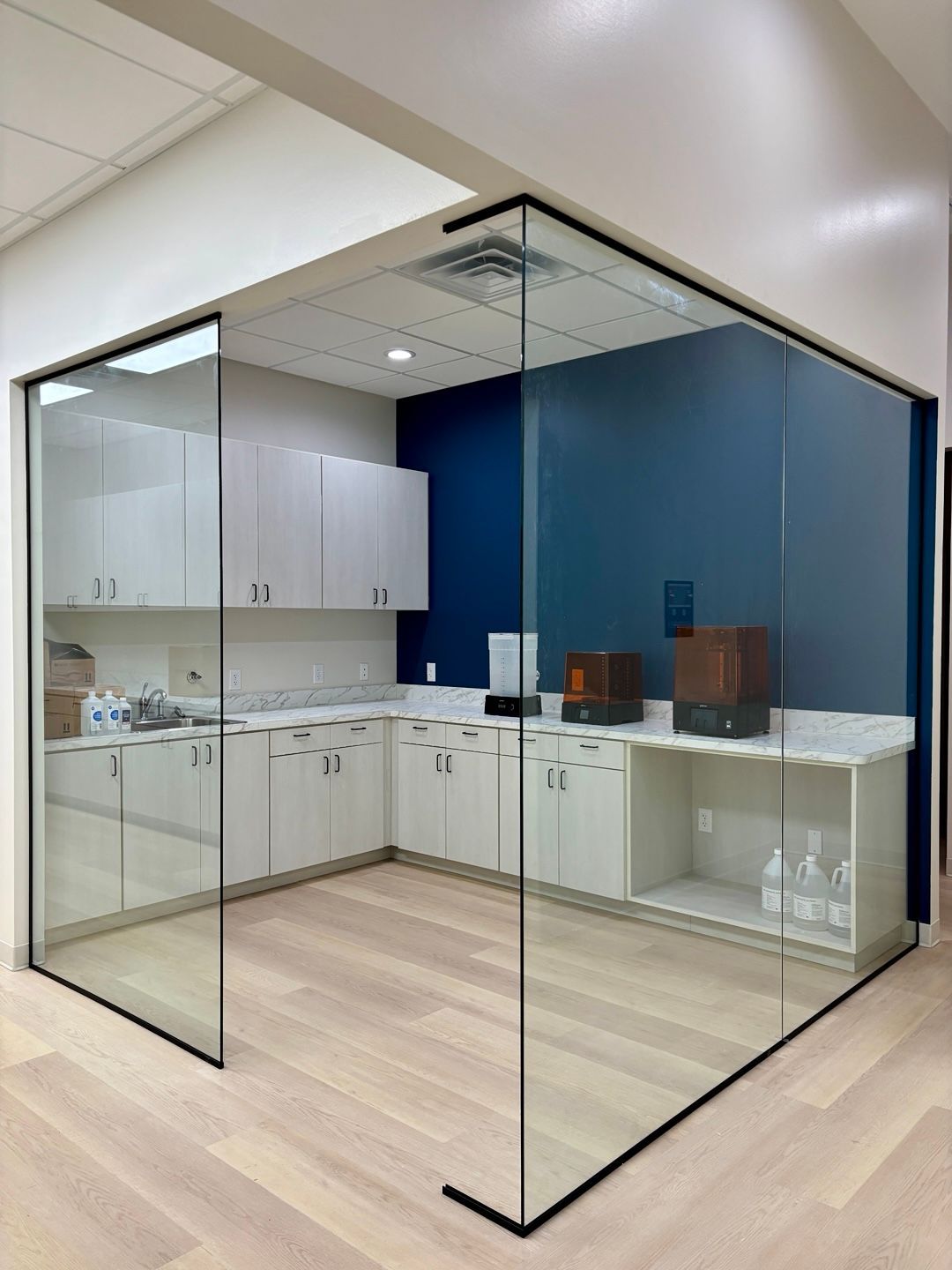 A dental office with a dental chair and a painting on the wall.