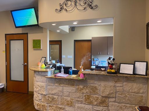 A dental office with a mickey mouse toy on the counter.