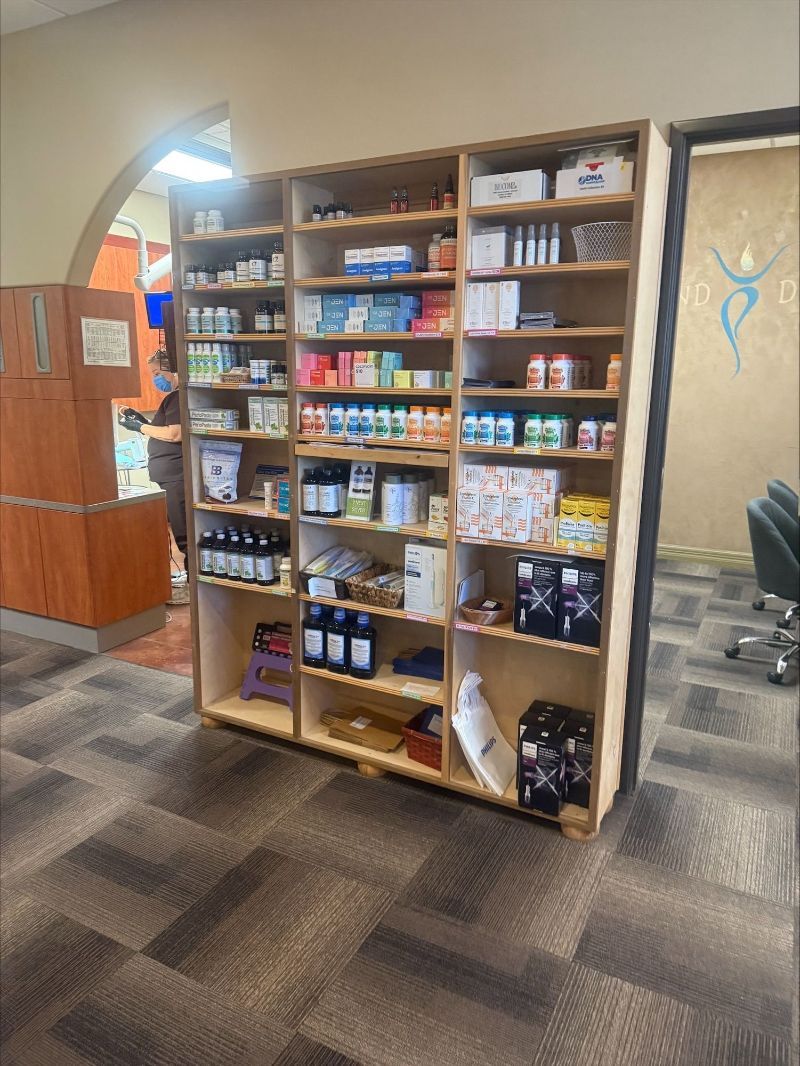 A pharmacy with a lot of shelves filled with lots of medicines.