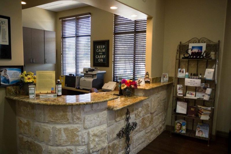 A reception desk in a dental office with a cross on it.