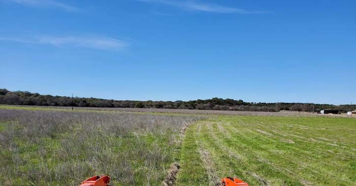 A person is riding a bike through a grassy field.