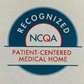 A blue and white circular logo for NCQA Patient-Centered Medical Home recognition.