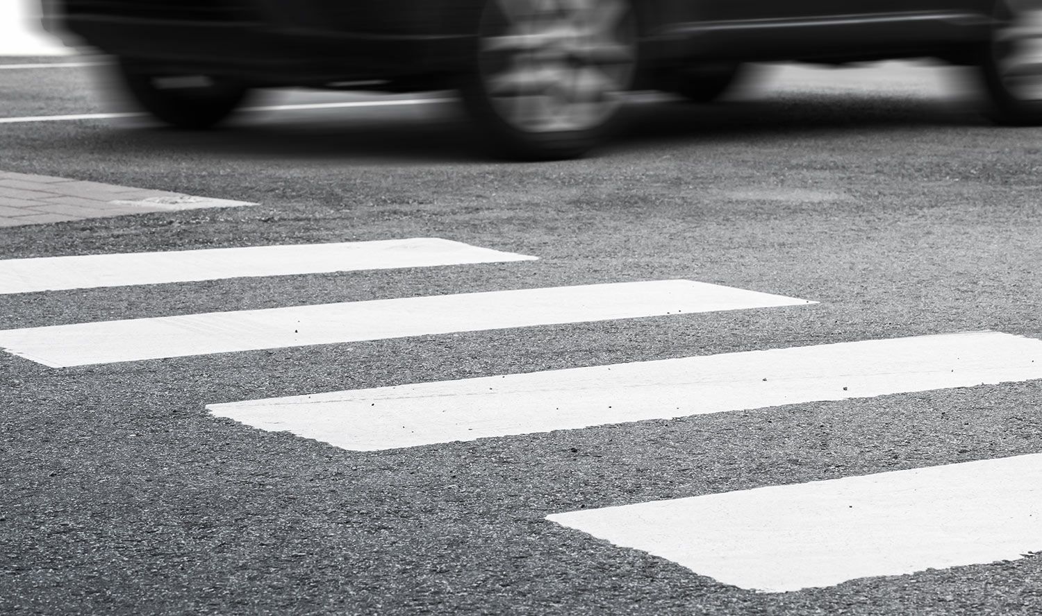 Pedestrian crosswalk with white stripes on asphalt
