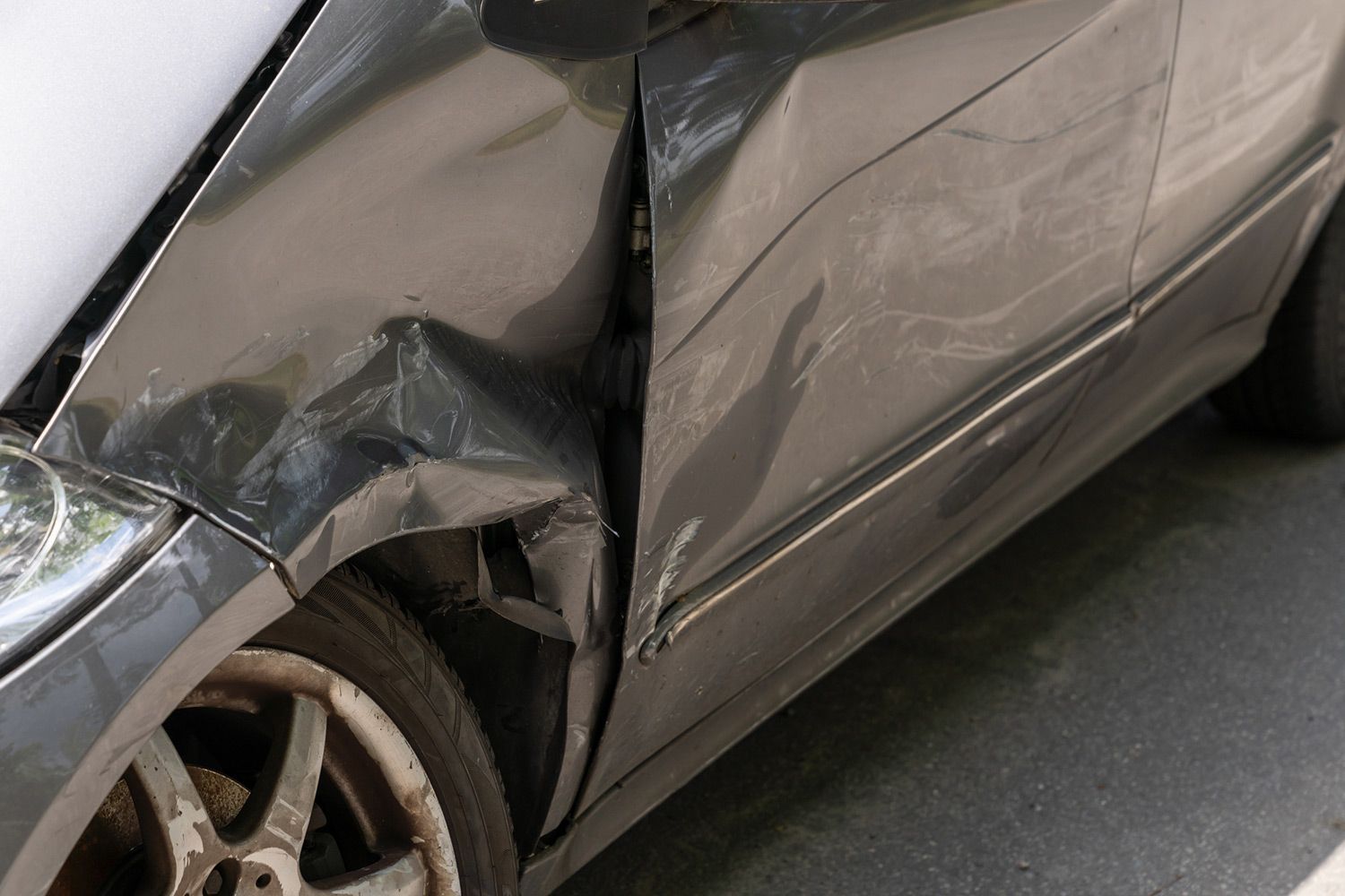 Damaged black car fender