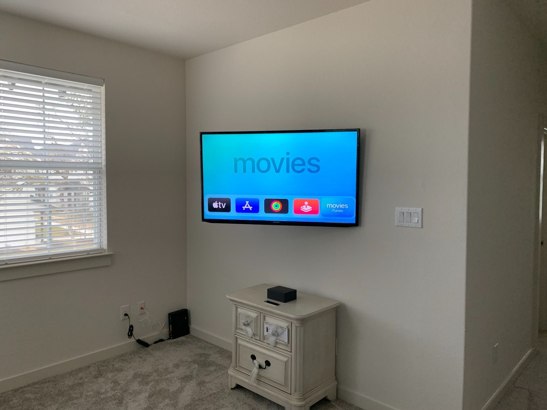 A bedroom with a flat screen tv mounted to the wall.