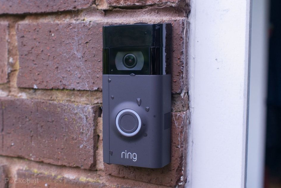 A ring doorbell is mounted on a brick wall.