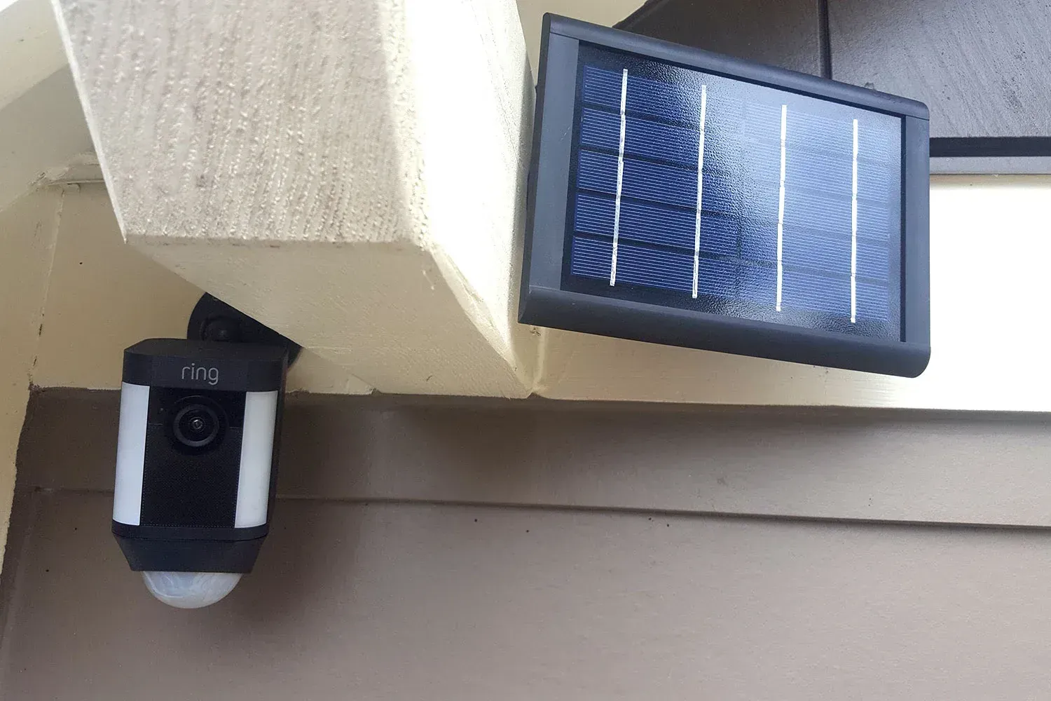 A ring security camera with a solar panel attached to it.