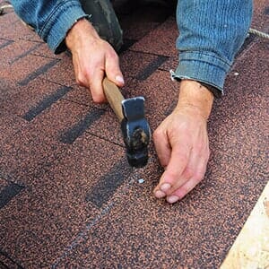 Roofer Installs Bitumen Roof Shingles — Pulaski Roofers in Baltimore