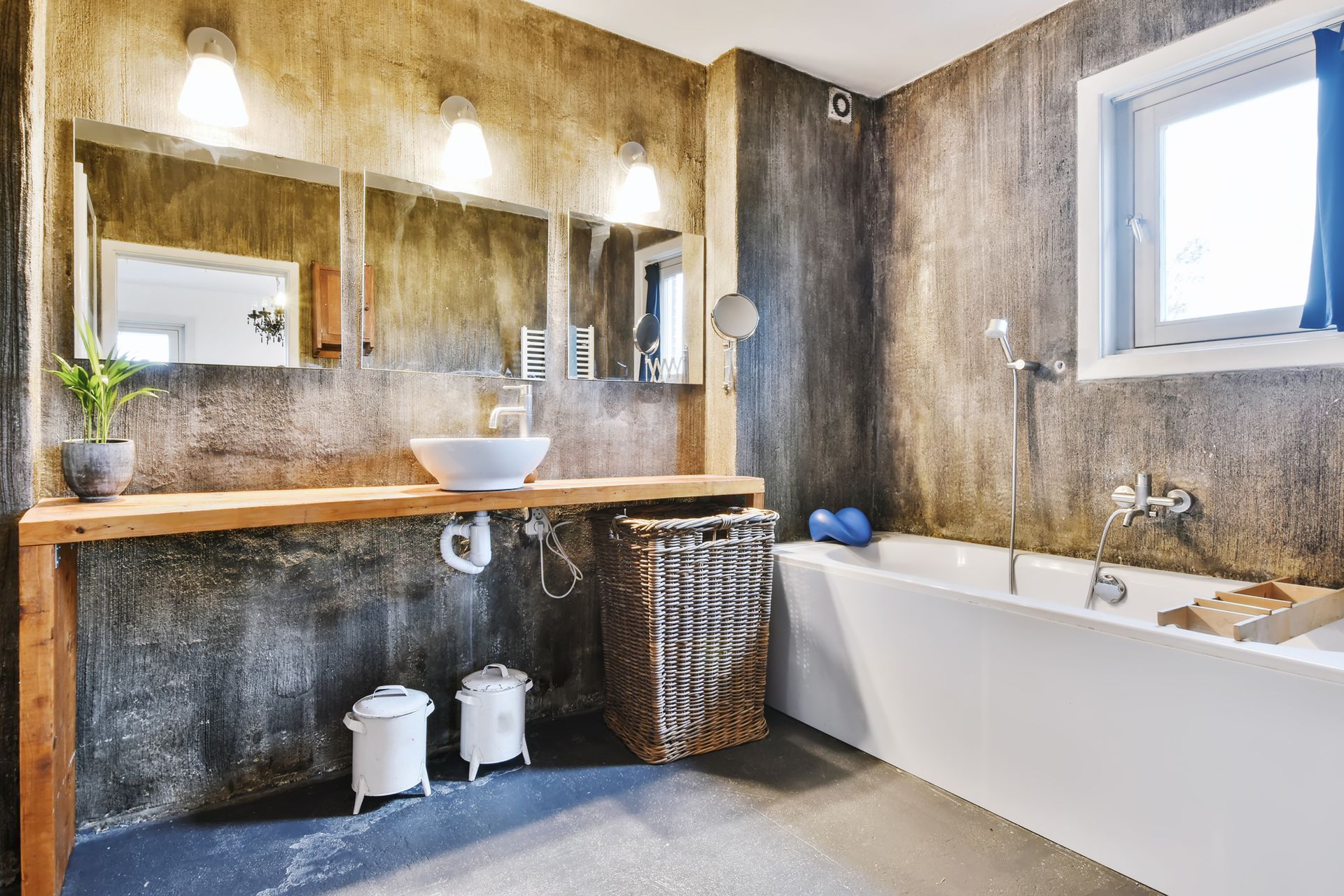 A bathroom with a sink , tub and mirror