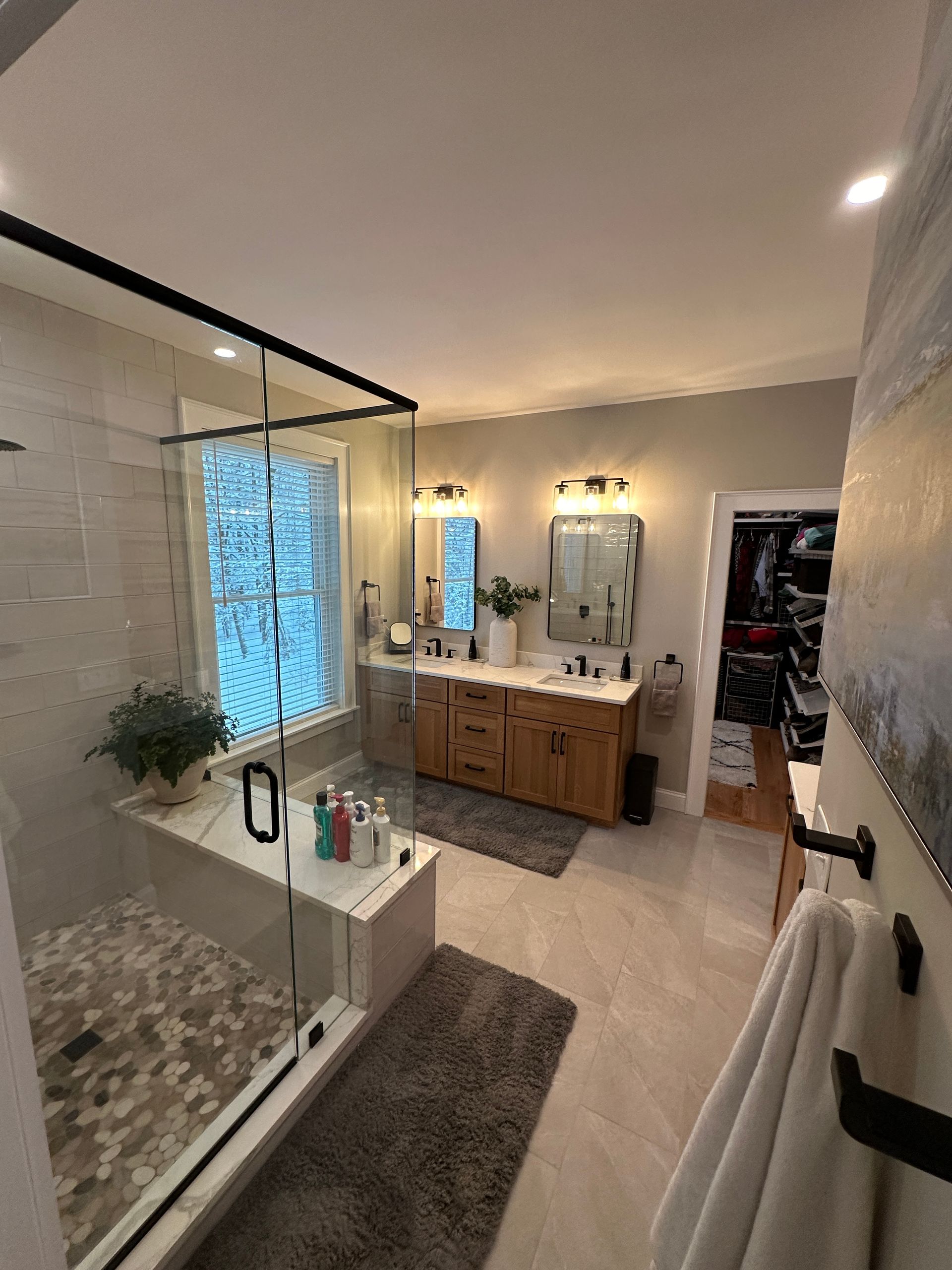 A bathroom with a walk in shower and a bathtub.