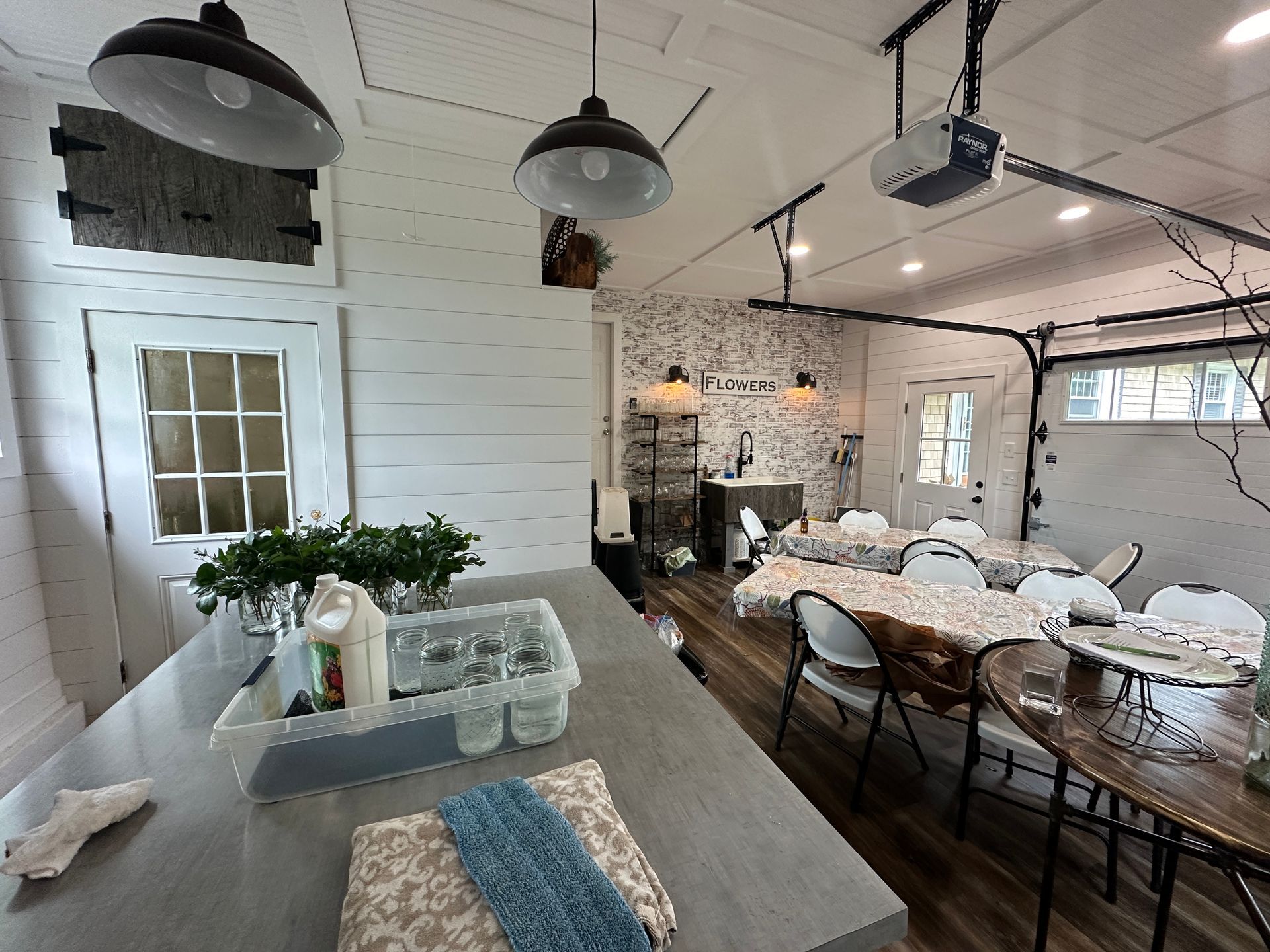 A kitchen and dining room in a garage with tables and chairs