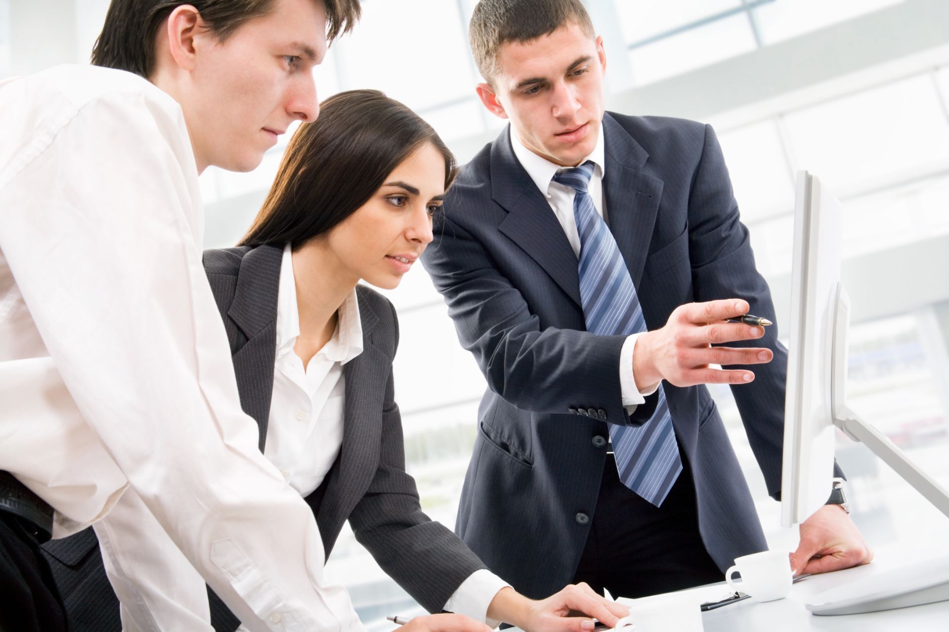 technology professionals looking at a computer