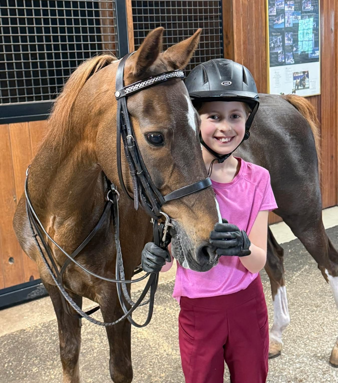photo of young boy walking Hackney Pony inside barn