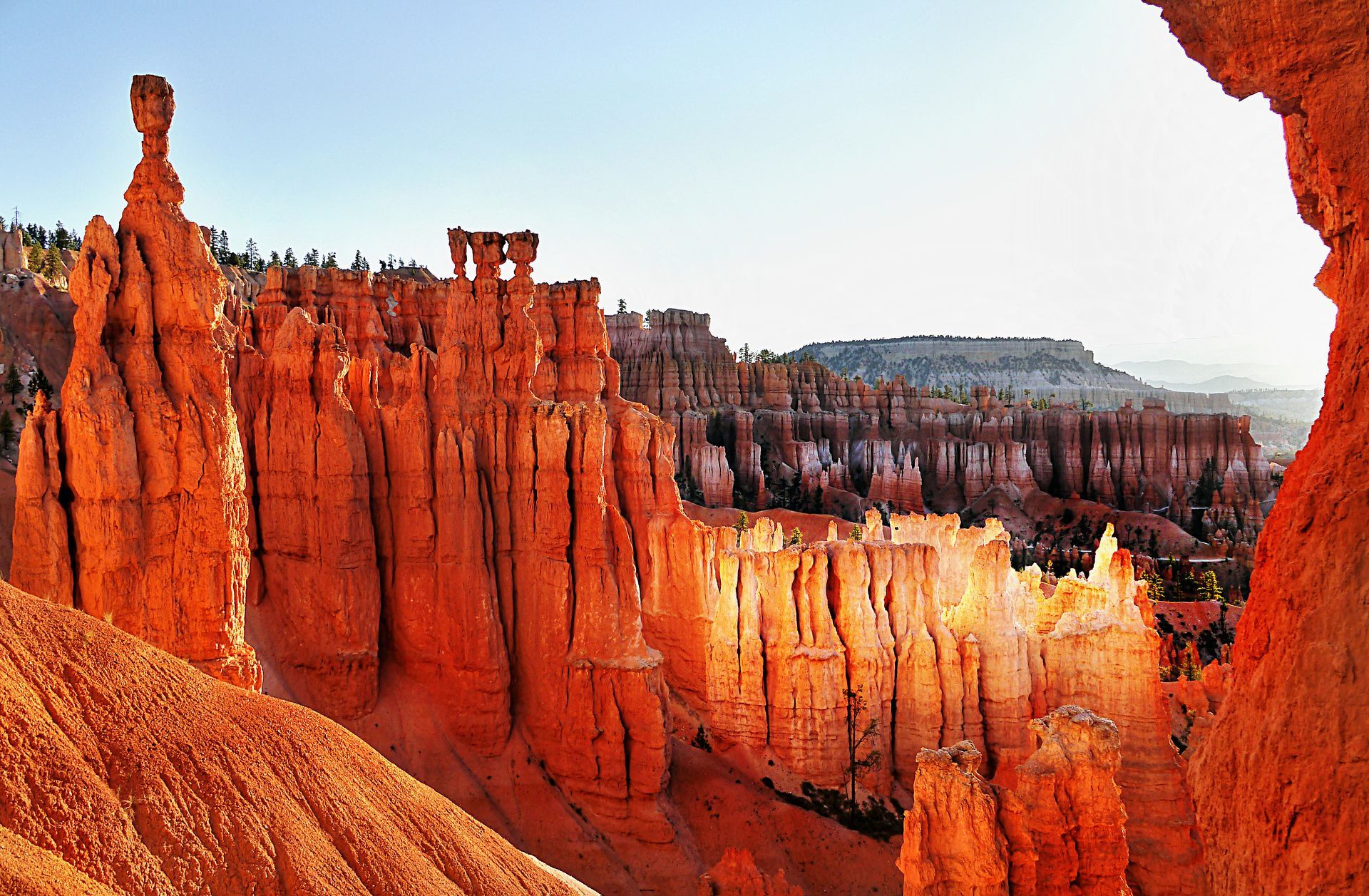 A view of a canyon through a hole in the rocks