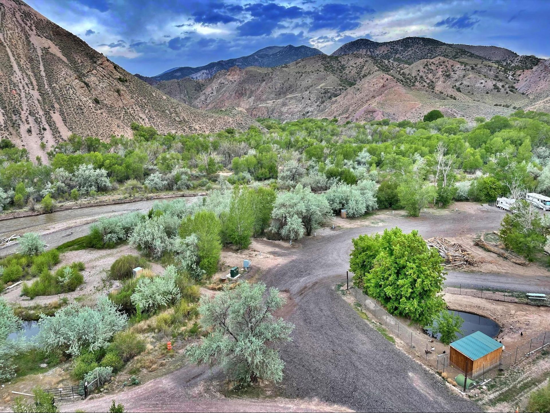 An aerial view of a river surrounded by trees and mountains.