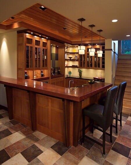 A Kitchen with A Large Wooden Counter and Chairs