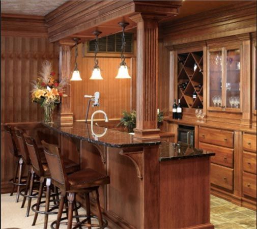 A Kitchen with Wooden Cabinets and A Bar with Stools