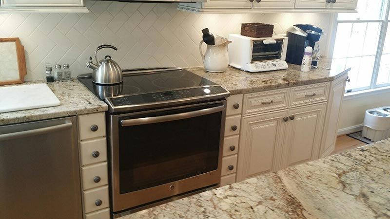 A Kitchen with A Stove , Dishwasher , and Toaster Oven.