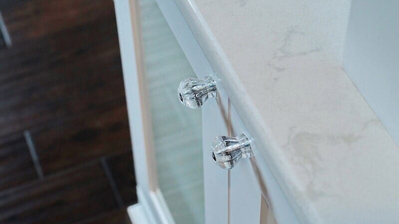 A Close up Of a Bathroom Vanity with Clear Knobs.