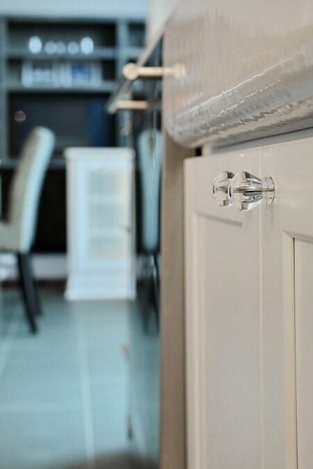 A Kitchen with White Cabinets and A Marble Counter Top.