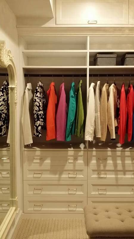 A Walk in Closet Filled with Clothes and A Mirror.