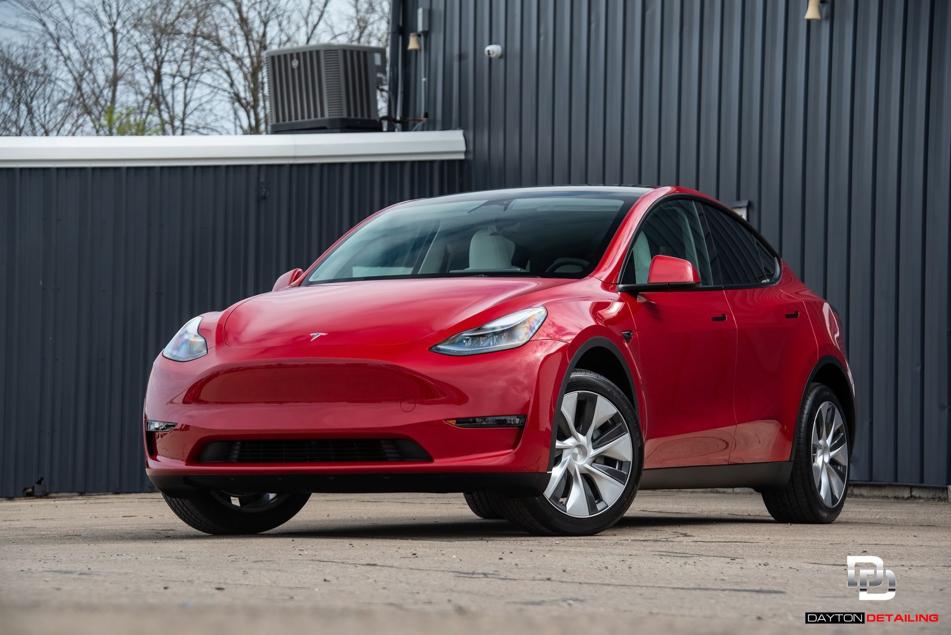front view of a ceramic-coated red Tesla vehicle