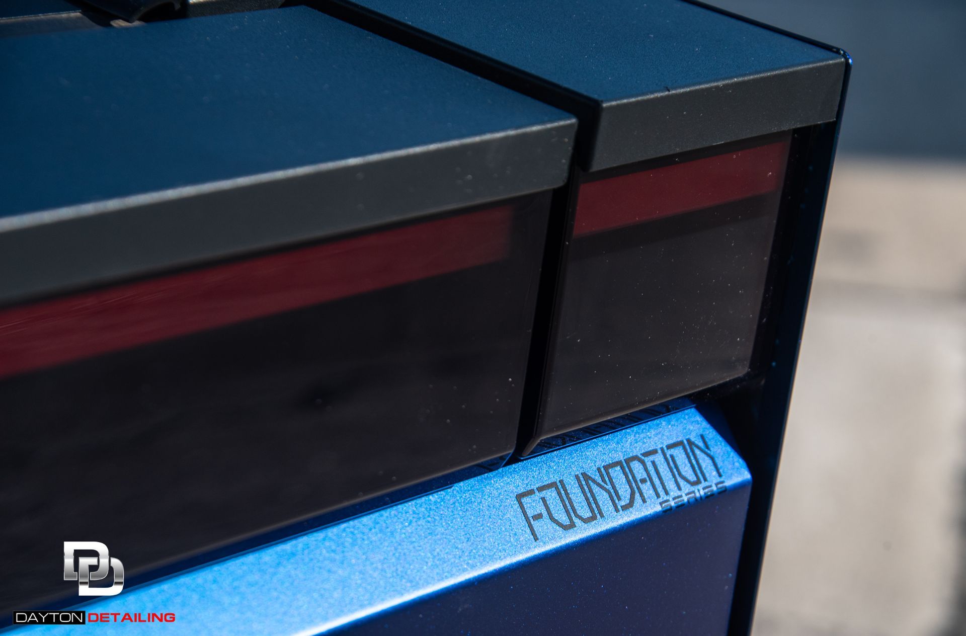 A blue and black Cybertruck with the word foundation on it