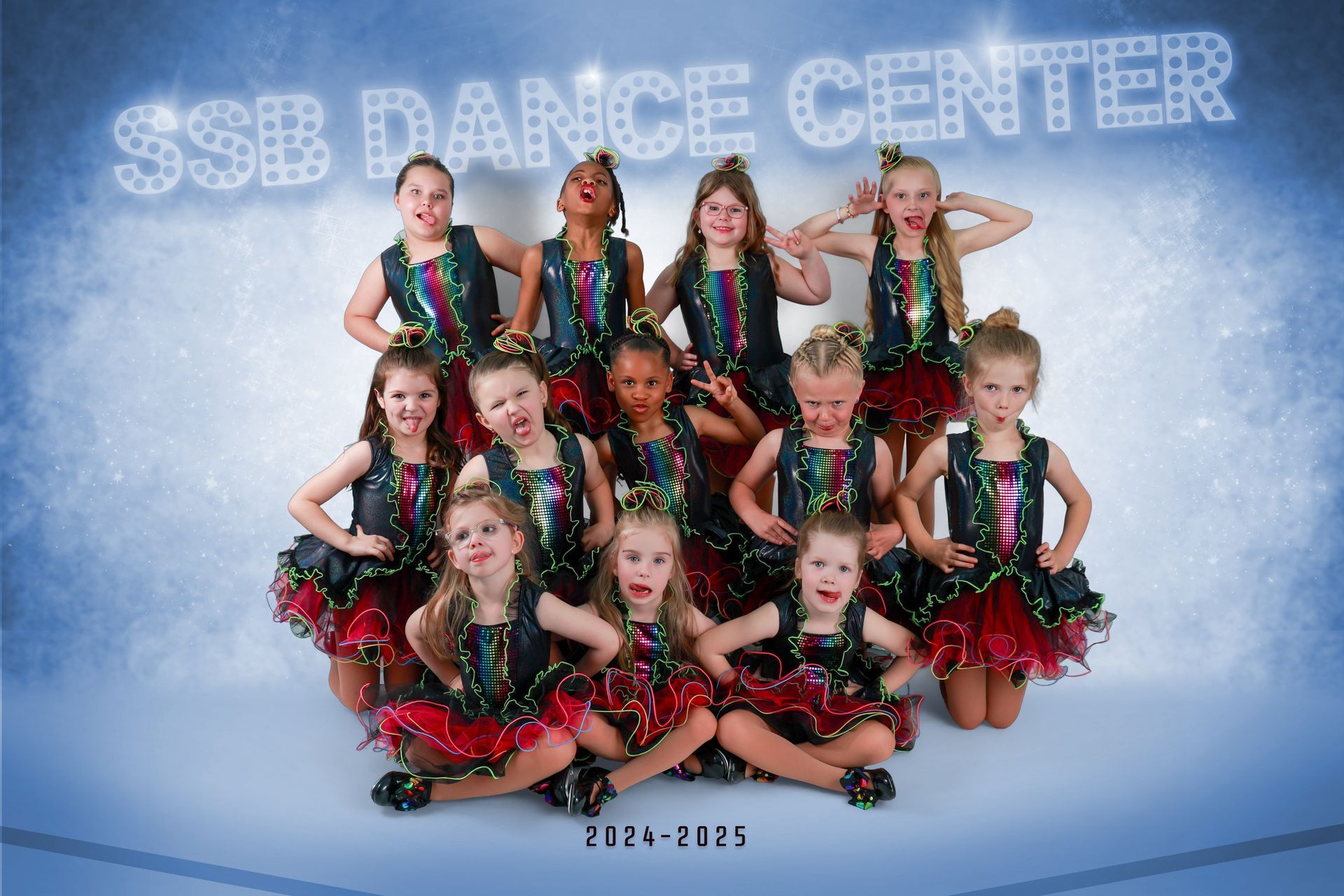 SSB Dance Center group of girls in matching costumes, posing with joyful expressions.