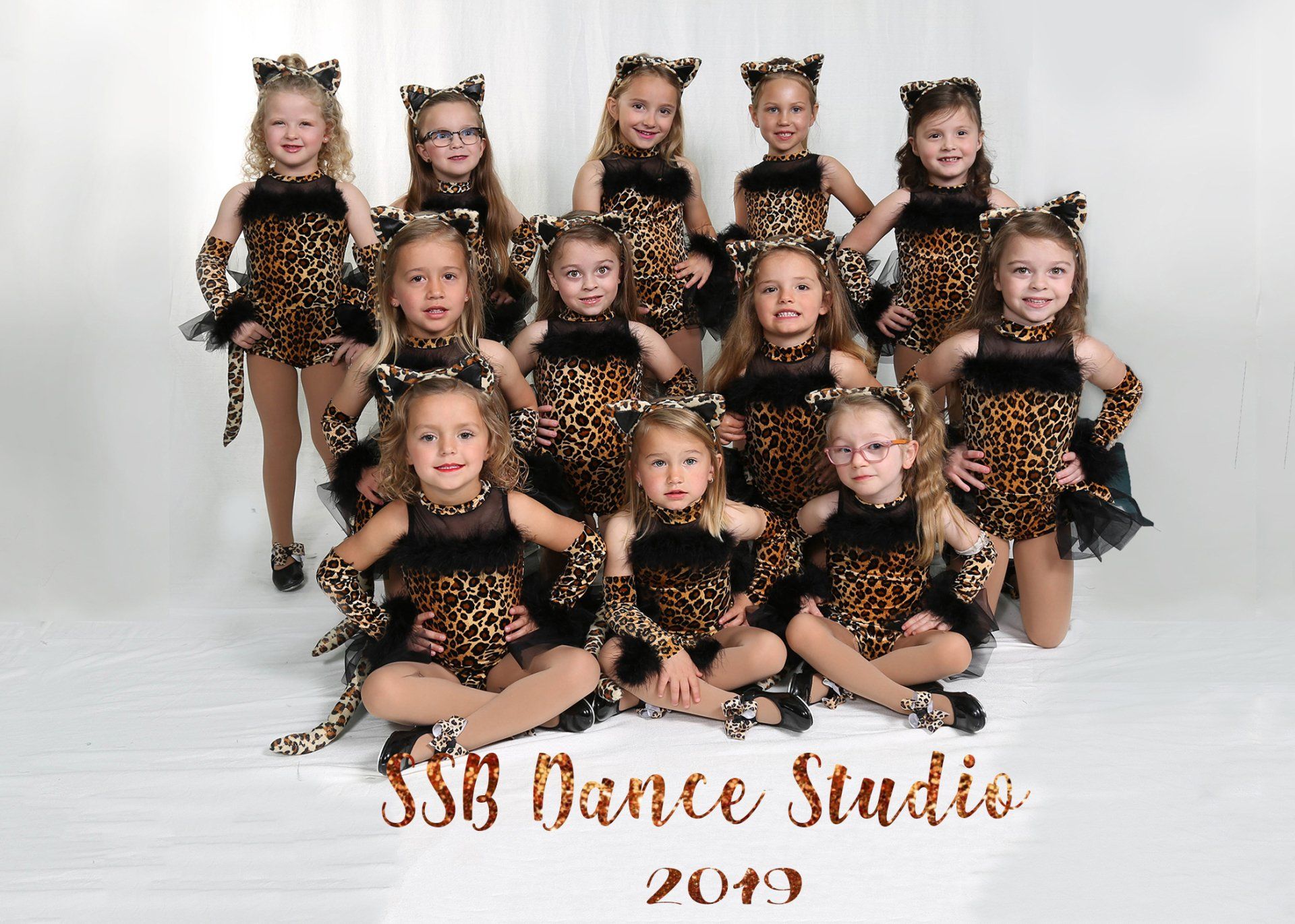 Young dancers in leopard print costumes pose for a group photo, SSB Dance Studio, 2019.