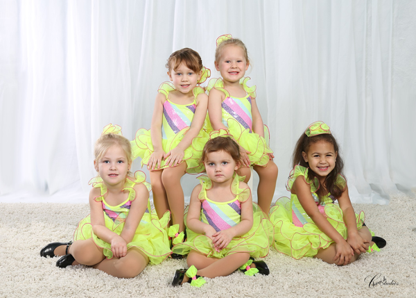 A group of girls wearing neon green dance costumes